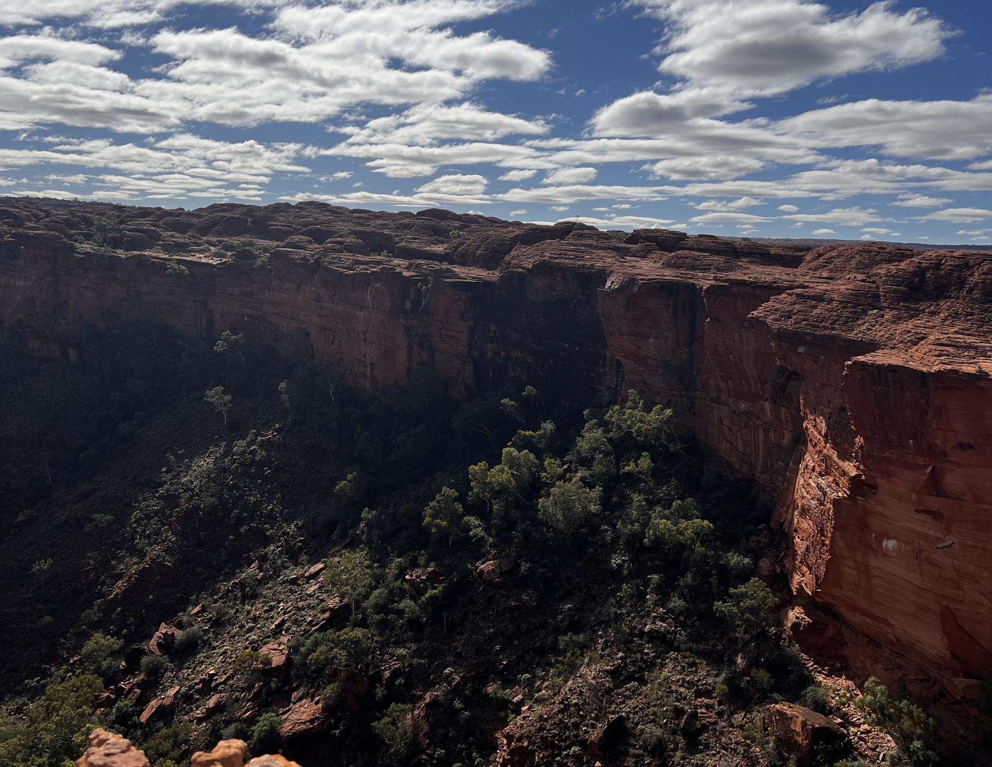 A canyon rim opening below a wide sky